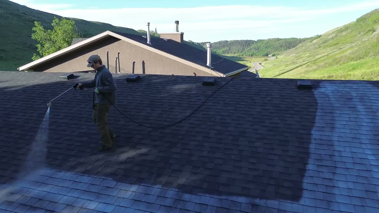 Technician applying ShingleLock to an asphalt roof